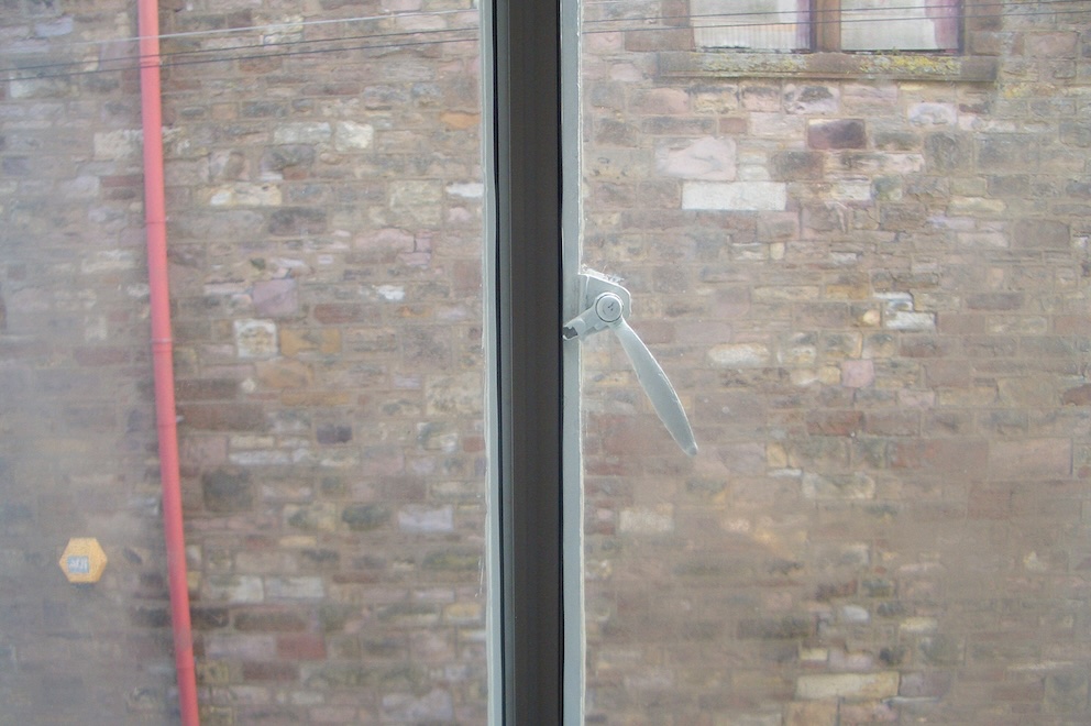 View out of a window of a brick wall