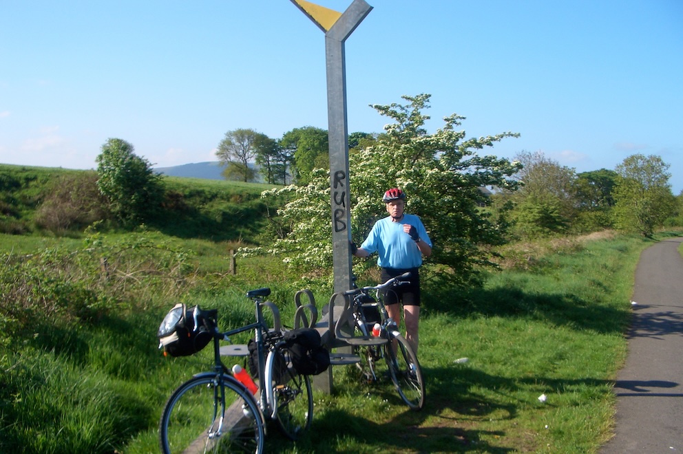 Peter by metal post with bikes propped against it