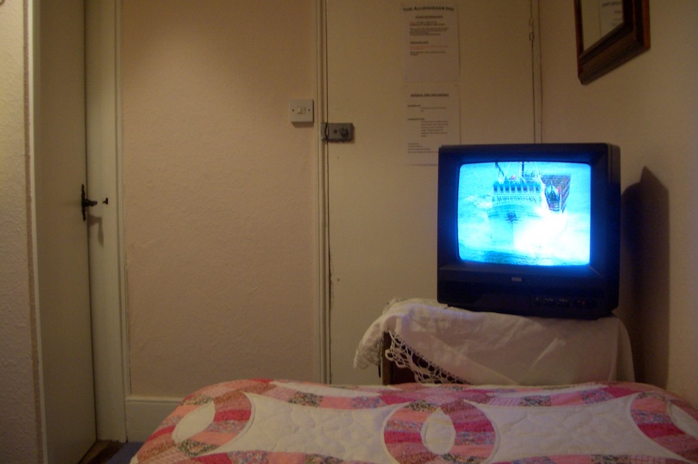 View from bed looking at tv propped on stand at the the foot